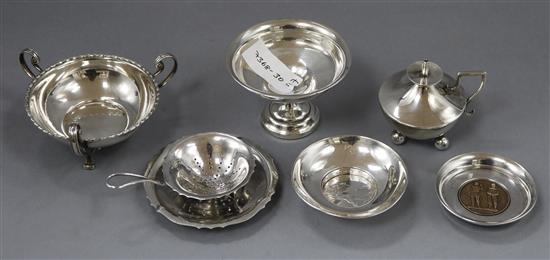 A George V silver table lighter, two trinket bowls, two white metal trinket dishes and a plated tea strainer